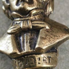 This brass bust appears to be a vintage docertive item / paperweight and pipe tamper or desk accessory depicting the composer Schubert, featuring his name clearly inscribed on the base.