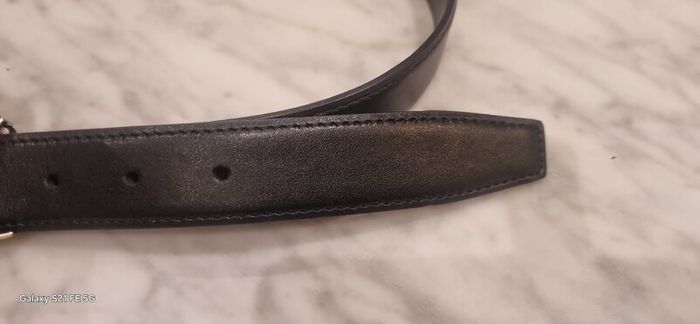 Black leather belt in the style of designer