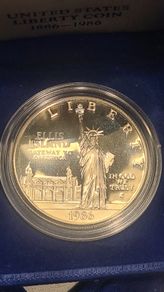 American 1986s silver dollar. Ellis Island