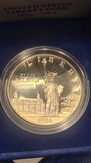 American 1986s silver dollar. Ellis Island