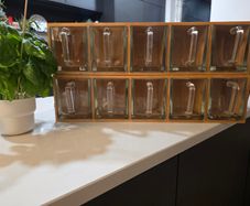 Wooden display shelf with glass jugs