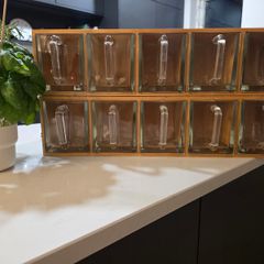 Wooden display shelf with glass jugs