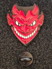 Red devil ,  pin back badge.