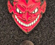 Red devil ,  pin back badge.