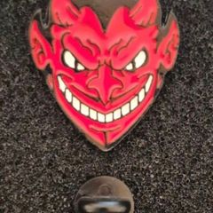 Red devil ,  pin back badge.