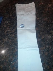 Boy's Nautica cream chino trousers. Age 10