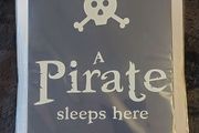 A pirate sleeps here metal sign