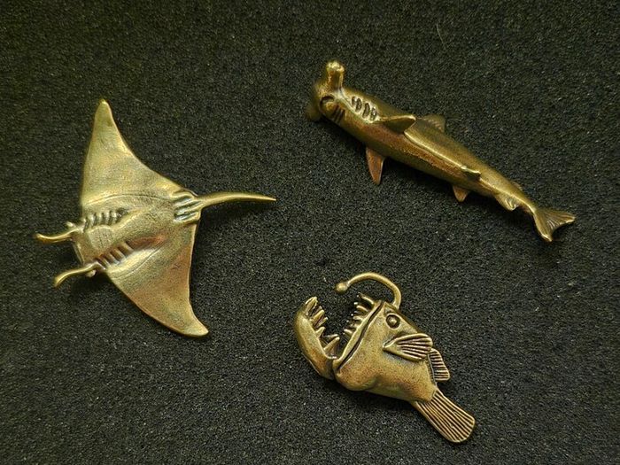3 brass fish.
