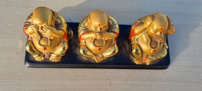 Three brass Buddha figurines