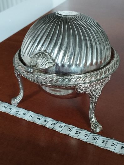 A vintage silver-plated butter dish or caviar bowl with a three-legged lid.