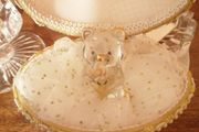 Glass hug bear in a shell case.