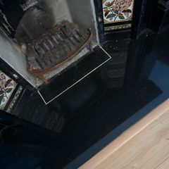 Victorian style cast iron fireplace with floral tiles