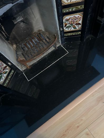 Victorian style cast iron fireplace with floral tiles
