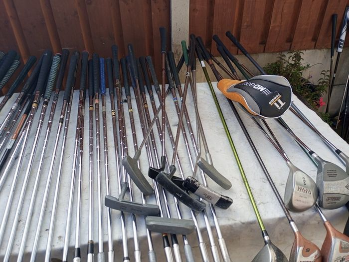 A selection of golf clubs and bags. All right handed clubs.