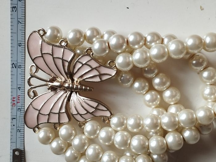 A beautiful faux pearl butterfly bracelet.