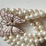 A beautiful faux pearl butterfly bracelet. Image 3