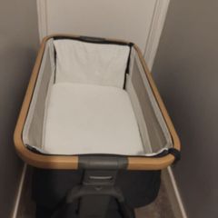 baby girls stuff next to me and knitted red and white blanket and a few brand new sets a baby changing mat and a cover for the mat all brand new hats mittens all 0.3 months and new born