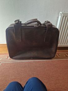 1leather suitcase and 1 faux leather suitcase.