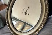 Antique style oval gold wall mirror.
