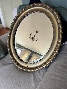 Antique style oval gold wall mirror.
