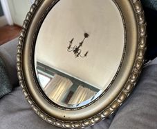Antique style oval gold wall mirror.