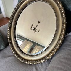 Antique style oval gold wall mirror.