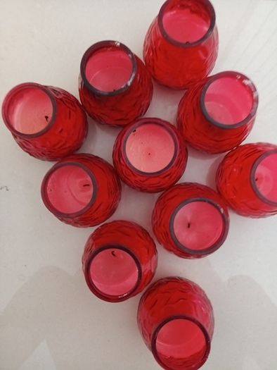 10 candles in red glass holders