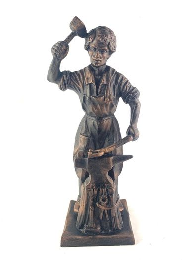 Vintage metal figurine of a blacksmith