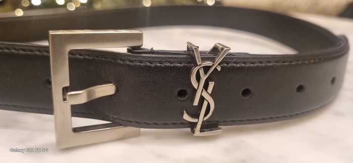 Black leather belt in the style of designer