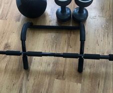 Home gym exercise equipment. Pull-up bar, medicine ball, dumbbells.