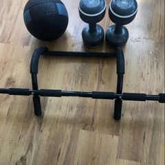Home gym exercise equipment. Pull-up bar, medicine ball, dumbbells.