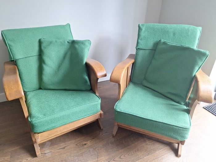 Pair of green arm chairs.