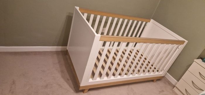 White and wooden cot