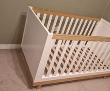 White and wooden cot