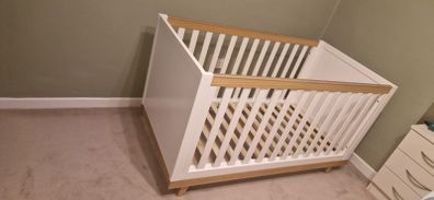 White and wooden cot