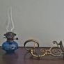 Victorian oil lamp on ornate brass sconce Image 2