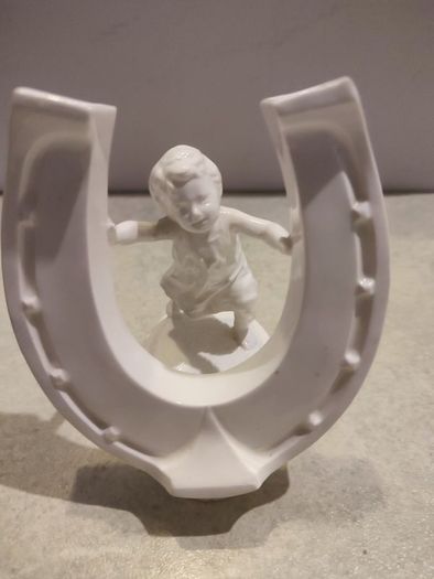 Rare find Cherub  Porcelain Horseshoe as flower vase held with child .