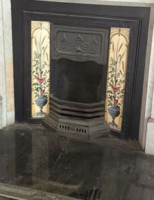 Two matching tiled cast iron fireplace inserts