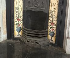 Two matching tiled cast iron fireplace inserts