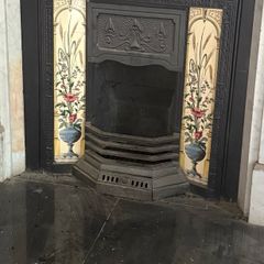 Two matching tiled cast iron fireplace inserts
