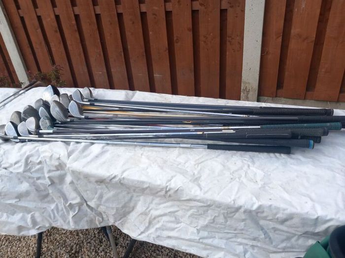 A selection of golf clubs and bags. Golf balls