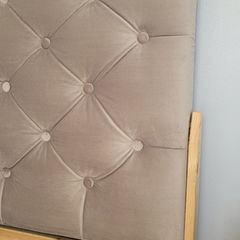 Single bed with cushioned headboard