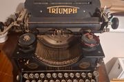Vintage Triumph manual typewriter with original Triumph branding and classic round keys.