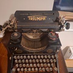 Vintage Triumph manual typewriter with original Triumph branding and classic round keys.