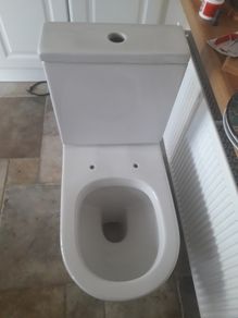 White ceramic toilet pan and cistern