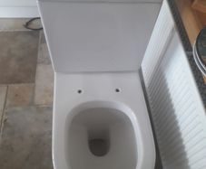 White ceramic toilet pan and cistern