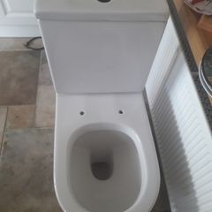 White ceramic toilet pan and cistern