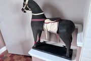 Vintage stuffed horse on plinth