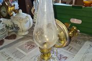 Old Oil lamp with Reflector Mirror, Clear Glass Base and a Tall Glass Chimney. It includes a brass burner, commonly used for wall mounting. Similar models are often categorized as Kerosene or Hurricane Lamps and can be used on tables or walls