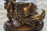 Bronzed Winged Cherub putto open seashell or leaf-shaped vessel with a scorpion like tail.